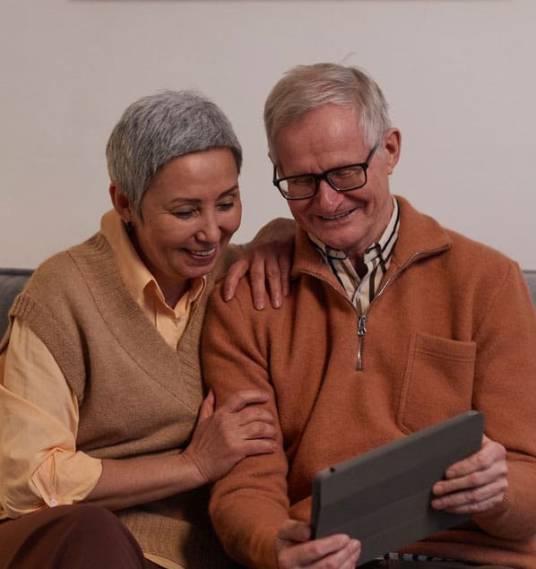 A happy elderly couple using an iPad together